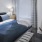 a bedroom with a bed and a chair